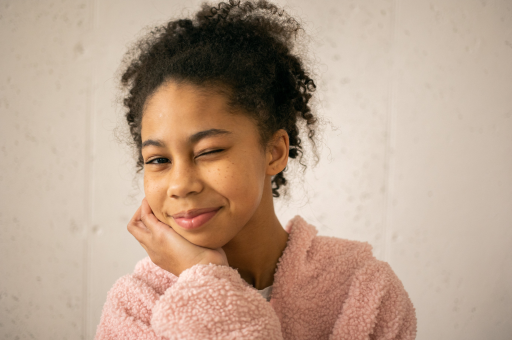 Young Women in a pink jacket winking